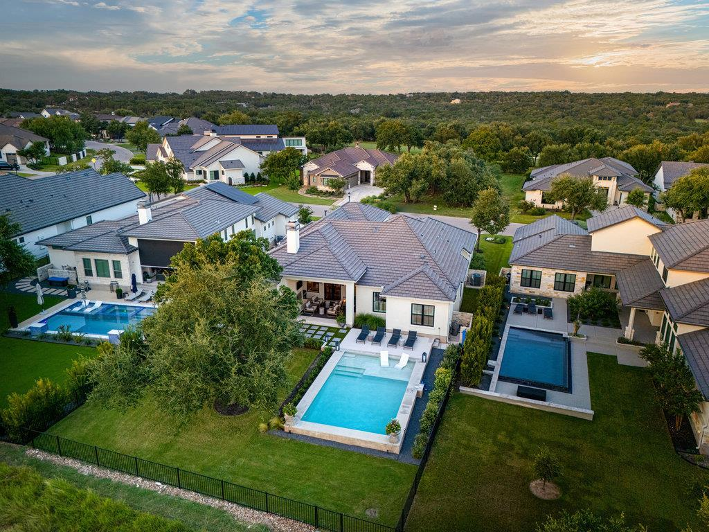 Aerial neighborhood view — pool, backyard and Cimarron Hills homes at sunset